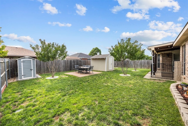 view of yard featuring a storage shed, an outdoor structure, a patio area, and outdoor dining space