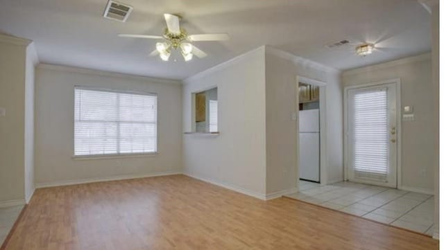 3233 S Univer Dr, Fort Worth, TX 76109 - spare room featuring crown molding, a ceiling fan, light wood-type flooring, and baseboards