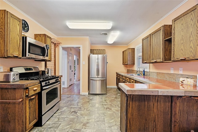 670 SE 22nd St SE, Paris, TX 75460 - kitchen featuring appliances with stainless steel finishes, a sink, a peninsula, light countertops, and ornamental molding