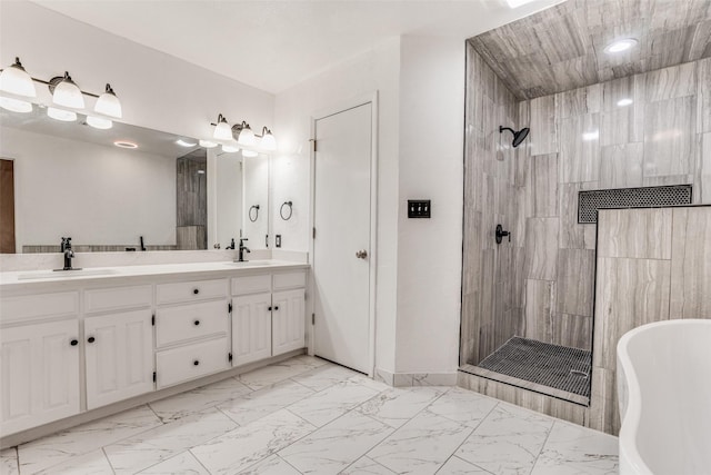 full bathroom with marble look tiles, a tile shower, double vanity, a freestanding tub, and recessed lighting
