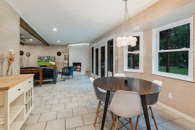 2012 S Meadow Way Cir, Arlington, TX 76015 - dining space with recessed lighting, wood walls, a fireplace, a chandelier, and light tile patterned floors