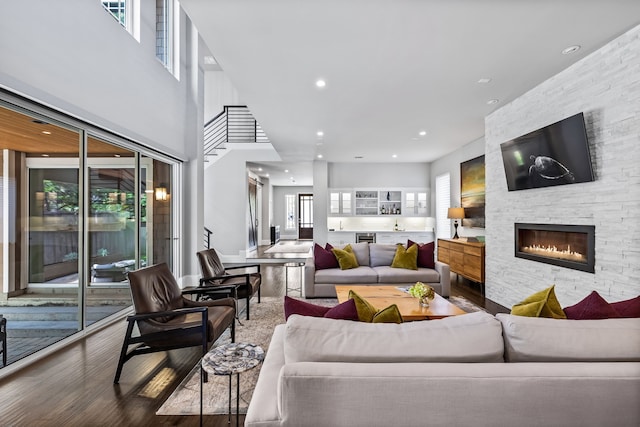 living room featuring wood finished floors, a fireplace, and recessed lighting
