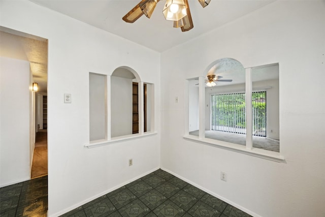 2302 Denmark Dr, Garland, TX 75040 - spare room featuring ceiling fan, arched walkways, and baseboards
