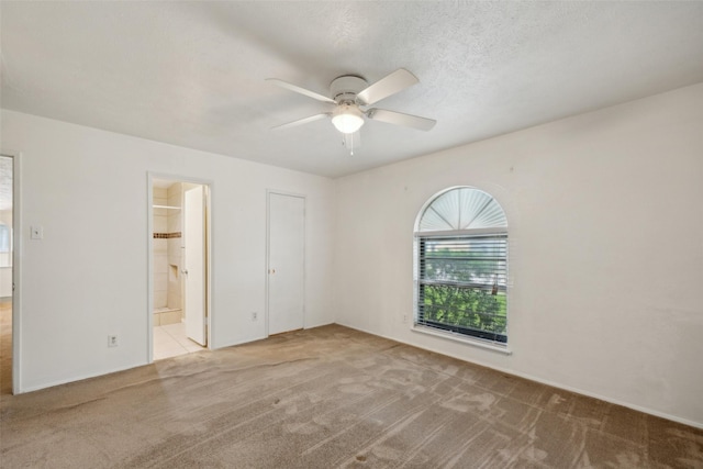 2302 Denmark Dr, Garland, TX 75040 - unfurnished bedroom featuring carpet floors, connected bathroom, and ceiling fan