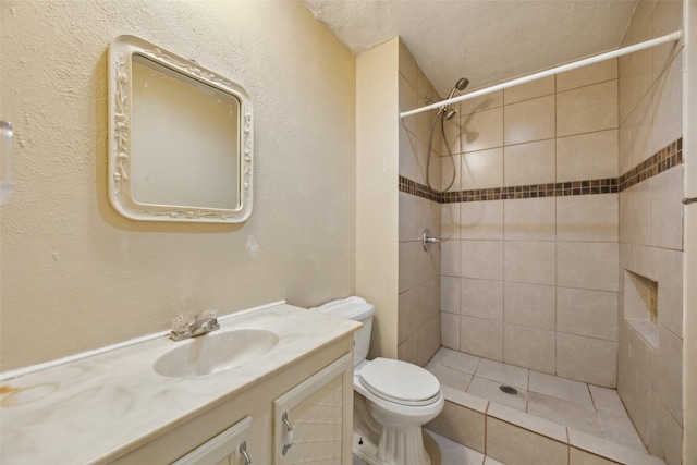 2302 Denmark Dr, Garland, TX 75040 - bathroom with toilet, a tile shower, vanity, and a textured ceiling