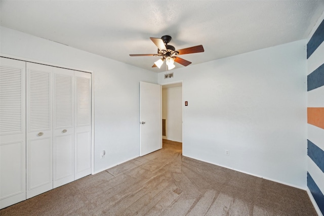2302 Denmark Dr, Garland, TX 75040 - unfurnished bedroom with a closet, carpet, and a ceiling fan