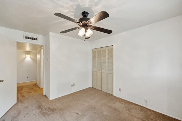 2302 Denmark Dr, Garland, TX 75040 - unfurnished bedroom with light colored carpet, a closet, ceiling fan, and baseboards