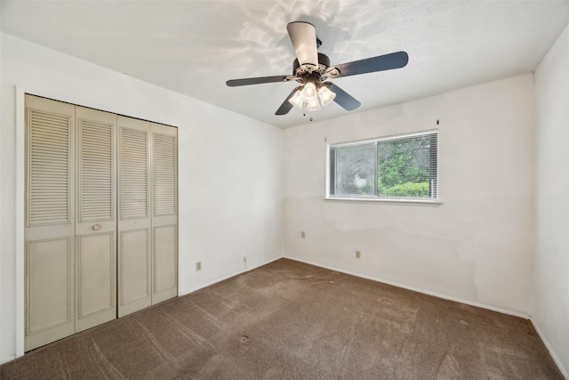 2302 Denmark Dr, Garland, TX 75040 - unfurnished bedroom featuring carpet, a closet, baseboards, and a ceiling fan