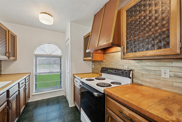 2302 Denmark Dr, Garland, TX 75040 - kitchen with electric range oven, light countertops, brown cabinets, backsplash, and a textured ceiling
