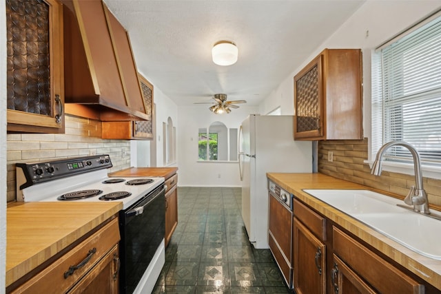 2302 Denmark Dr, Garland, TX 75040 - kitchen featuring range with electric stovetop, dark floors, plenty of natural light, and tasteful backsplash