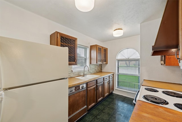 2302 Denmark Dr, Garland, TX 75040 - kitchen featuring freestanding refrigerator, a sink, dishwashing machine, premium range hood, and butcher block countertops