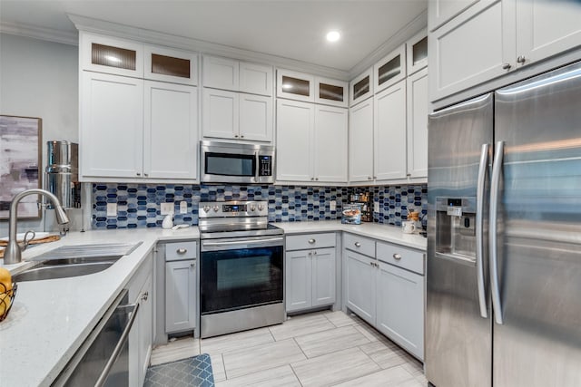 1219 Haines Ave, Dallas, TX 75208 - kitchen featuring stainless steel appliances, crown molding, backsplash, glass insert cabinets, and recessed lighting