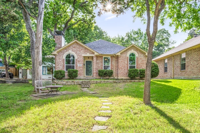1219 Haines Ave, Dallas, TX 75208 - ranch-style home featuring a chimney, a front lawn, brick siding, and roof with shingles