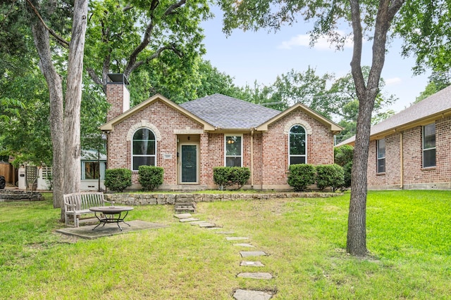 1219 Haines Ave, Dallas, TX 75208 - single story home featuring a chimney, brick siding, a front yard, and roof with shingles