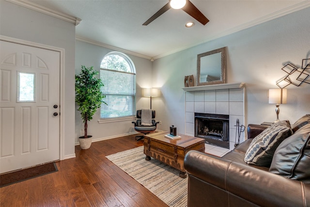 1219 Haines Ave, Dallas, TX 75208 - living room featuring a ceiling fan, a tile fireplace, crown molding, wood finished floors, and recessed lighting