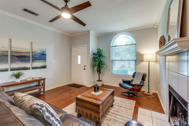 1219 Haines Ave, Dallas, TX 75208 - living area featuring wood finished floors, crown molding, ceiling fan, and a fireplace