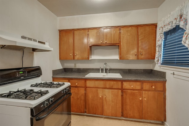 1406 E Cortez Dr, Wichita Falls, TX 76306 - kitchen featuring gas range gas stove, a sink, under cabinet range hood, and dark countertops