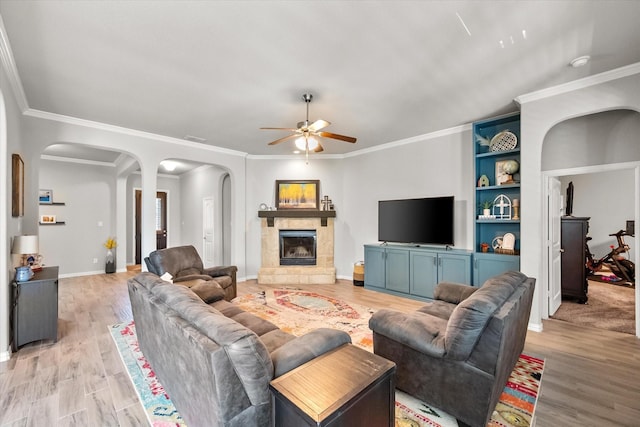 3626 Green Bluff Ct, Midlothian, TX 76065 - living room with arched walkways, a ceiling fan, light wood-style floors, and ornamental molding