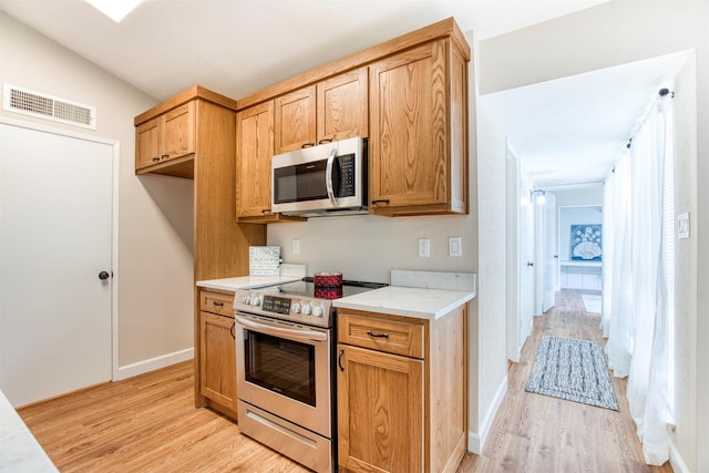 4626 Nervin St, The Colony, TX 75056 - kitchen with appliances with stainless steel finishes, light wood finished floors, and baseboards