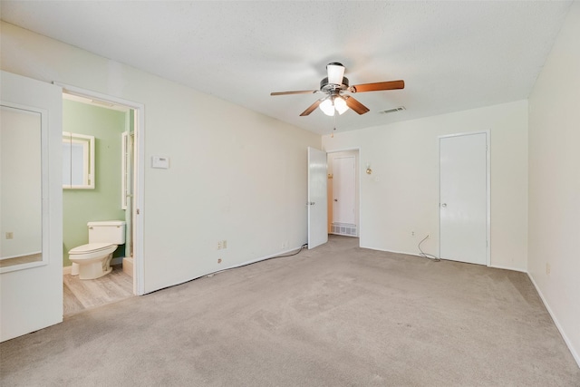240 N Bryan Pl, Mesquite, TX 75149 - unfurnished bedroom with carpet floors, connected bathroom, and a ceiling fan