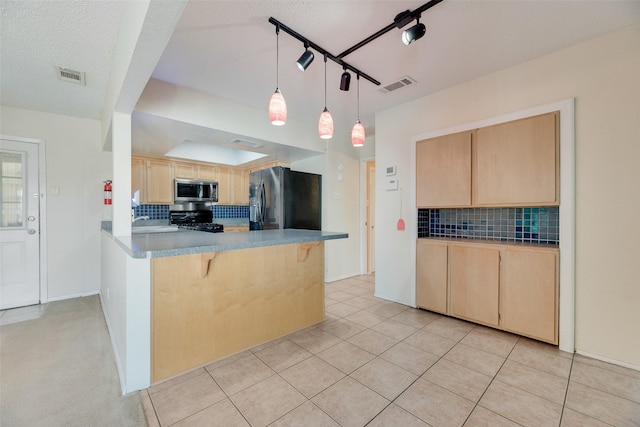 240 N Bryan Pl, Mesquite, TX 75149 - kitchen with appliances with stainless steel finishes, light brown cabinets, backsplash, and a breakfast bar