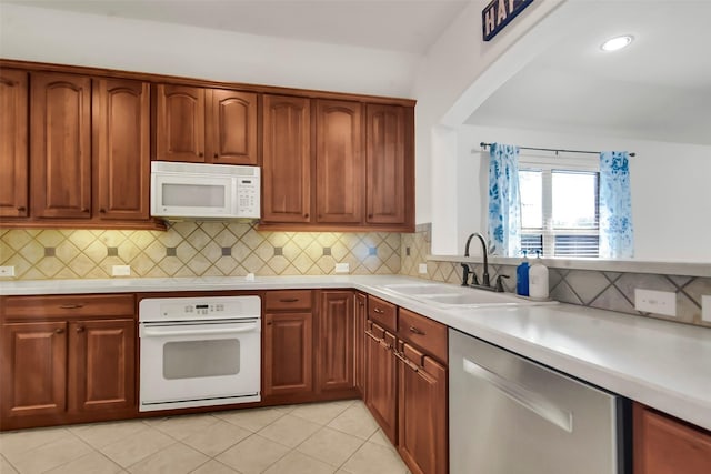 201 Villanova Dr, Van Alstyne, TX 75495 - kitchen featuring white appliances, a sink, light countertops, and backsplash