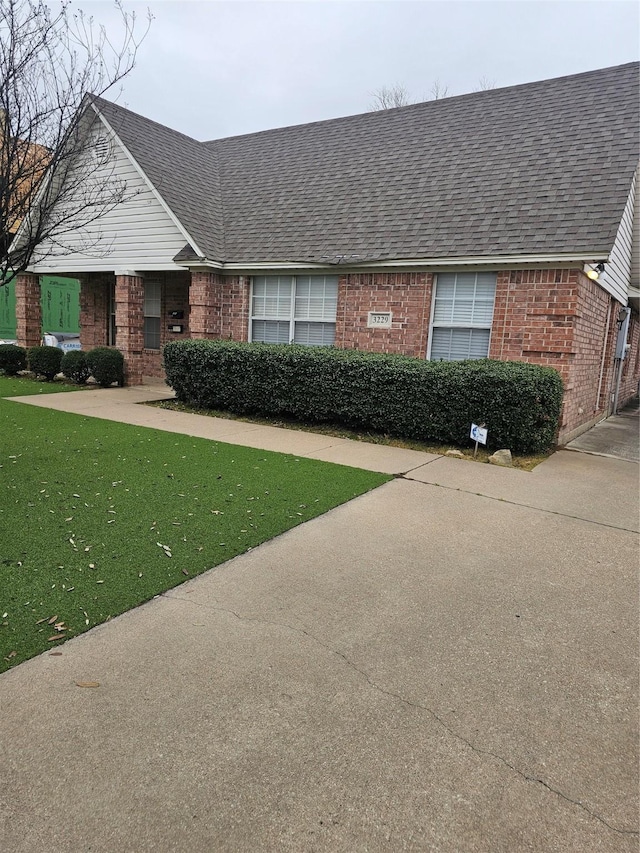3233 S Univ Dr, Fort Worth, TX 76109 - view of front of property featuring brick siding, a shingled roof, and a front yard
