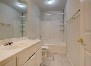 3233 S Univ Dr, Fort Worth, TX 76109 - bathroom featuring tile patterned floors, toilet, vanity, and shower / tub combination