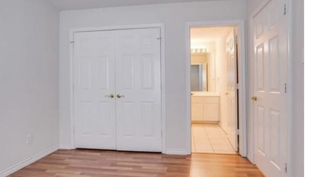 3233 S Univ Dr, Fort Worth, TX 76109 - unfurnished bedroom featuring light wood-style floors, ensuite bathroom, a closet, and baseboards