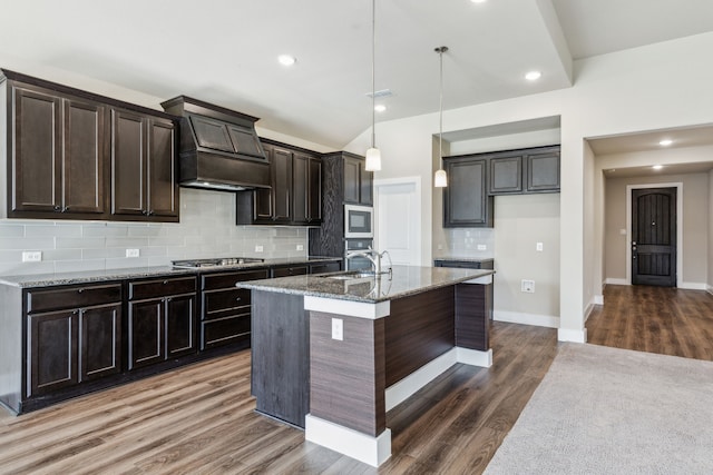 5408 Fairdale Dr, Denton, TX 76207 - kitchen with stainless steel appliances, custom range hood, a sink, stone countertops, and backsplash