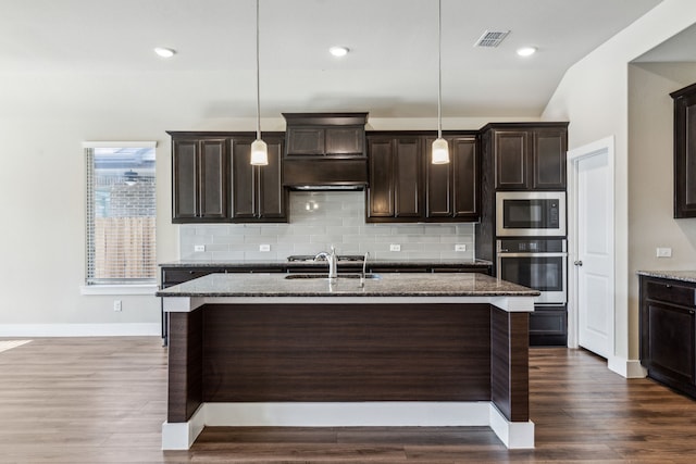 5408 Fairdale Dr, Denton, TX 76207 - kitchen featuring stainless steel appliances, dark stone counters, a sink, tasteful backsplash, and recessed lighting