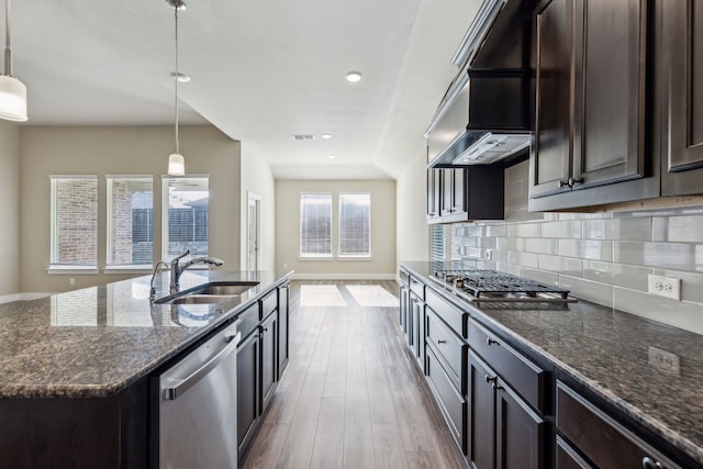 5408 Fairdale Dr, Denton, TX 76207 - kitchen with stainless steel appliances, a sink, wood finished floors, dark stone counters, and dark brown cabinets