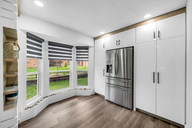 4122 Azalea Ln, Garland, TX 75043 - kitchen featuring stainless steel refrigerator with ice dispenser, wood finished floors, recessed lighting, and white cabinetry