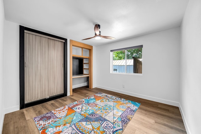 4122 Azalea Ln, Garland, TX 75043 - unfurnished bedroom with baseboards, wood finished floors, and a ceiling fan