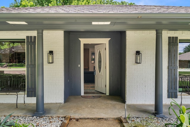 4122 Azalea Ln, Garland, TX 75043 - doorway to property featuring brick siding and covered porch