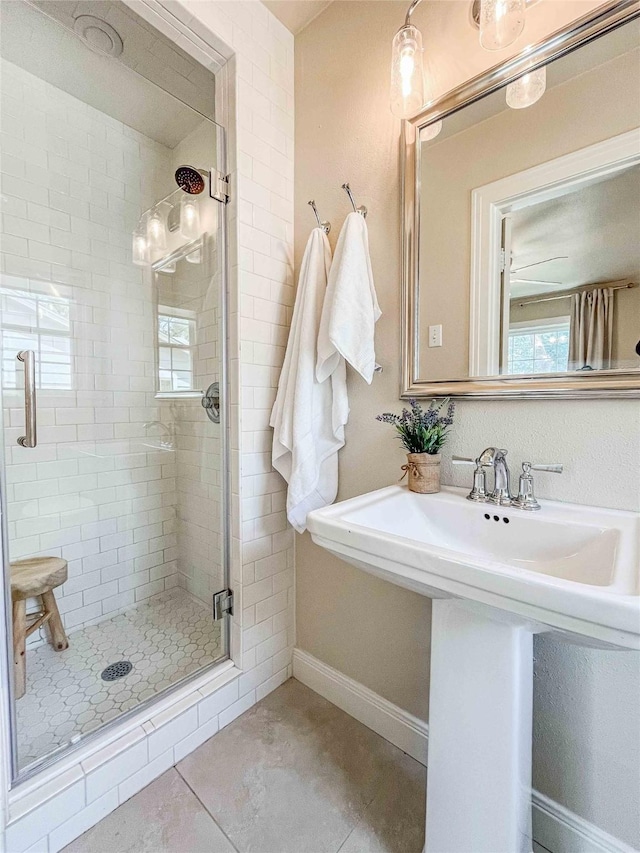 3418 S 11th St, Abilene, TX 79605 - bathroom featuring a stall shower, healthy amount of natural light, baseboards, and a sink