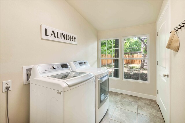 3418 S 11th St, Abilene, TX 79605 - laundry room featuring washing machine and clothes dryer, baseboards, and light tile patterned floors