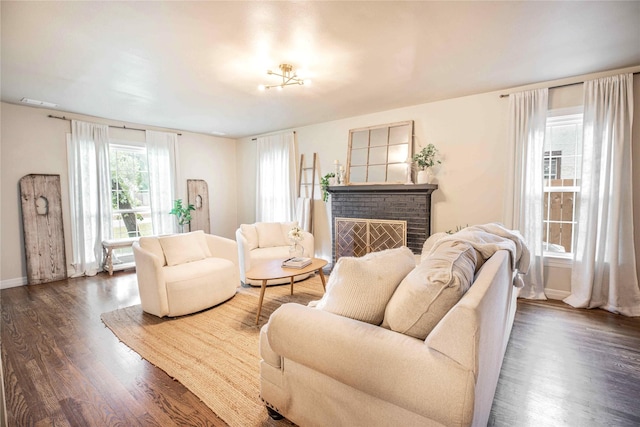 3418 S 11th St, Abilene, TX 79605 - living room featuring dark wood finished floors, a brick fireplace, and baseboards