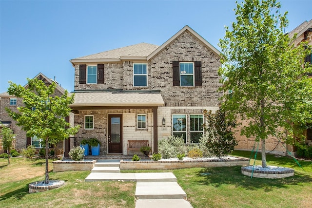 414 Kirkland Rd, Garland, TX 75044 - view of front facade with a front lawn, brick siding, covered porch, and roof with shingles