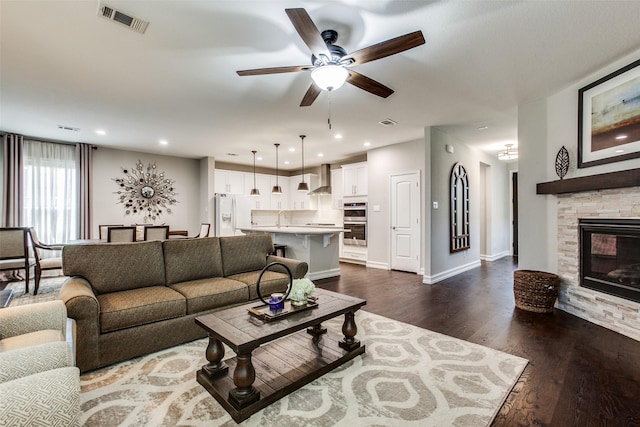 414 Kirkland Rd, Garland, TX 75044 - living area featuring a ceiling fan, dark wood-style floors, a fireplace, baseboards, and recessed lighting
