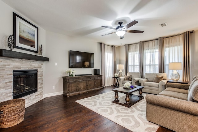414 Kirkland Rd, Garland, TX 75044 - living room featuring a ceiling fan, wood finished floors, a stone fireplace, and baseboards