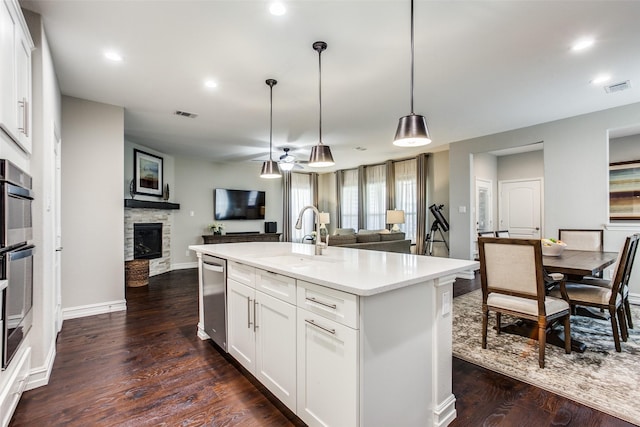 414 Kirkland Rd, Garland, TX 75044 - kitchen with open floor plan, a sink, stainless steel dishwasher, a fireplace, and recessed lighting