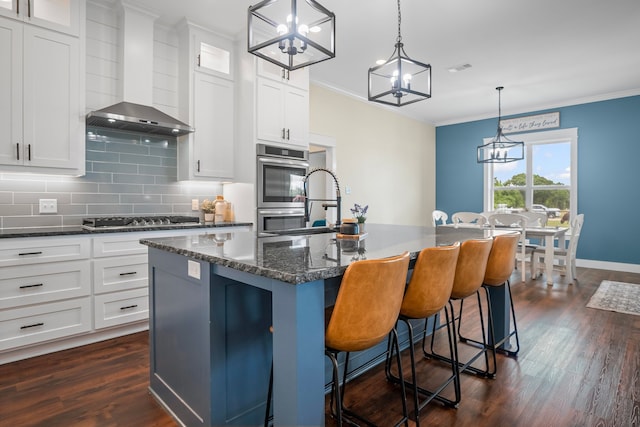 174 Rs County Road 3160, Emory, TX 75440 - kitchen featuring wall chimney exhaust hood, stainless steel appliances, dark wood-style flooring, crown molding, and backsplash