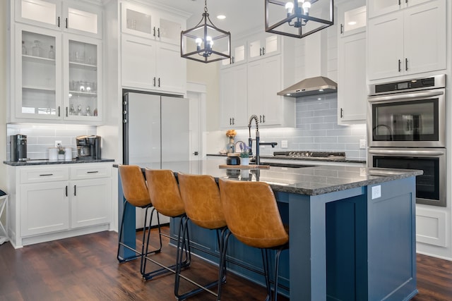 174 Rs County Road 3160, Emory, TX 75440 - kitchen with double oven, a chandelier, freestanding refrigerator, decorative backsplash, and white cabinetry