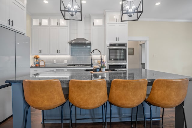 174 Rs County Road 3160, Emory, TX 75440 - kitchen featuring stainless steel appliances, a chandelier, ornamental molding, a center island with sink, and backsplash
