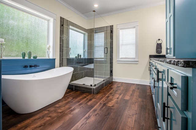 174 Rs County Road 3160, Emory, TX 75440 - bathroom with wood finished floors, ornamental molding, a stall shower, a soaking tub, and baseboards