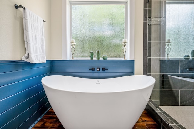 174 Rs County Road 3160, Emory, TX 75440 - bathroom with wood finished floors, a soaking tub, and a walk in shower