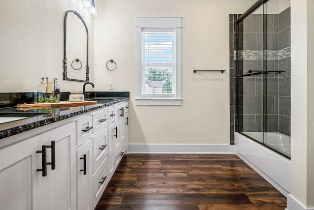174 Rs County Road 3160, Emory, TX 75440 - bathroom with wood finished floors, double vanity, shower / bath combination with glass door, and baseboards