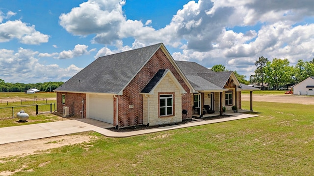 174 Rs County Road 3160, Emory, TX 75440 - view of front of home with concrete driveway, stone siding, a shingled roof, brick siding, and a garage