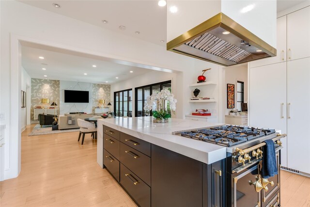 3713 Greenbrier Dr, University Park, TX 75225 - kitchen featuring stainless steel stove, island range hood, white cabinetry, light wood finished floors, and modern cabinets